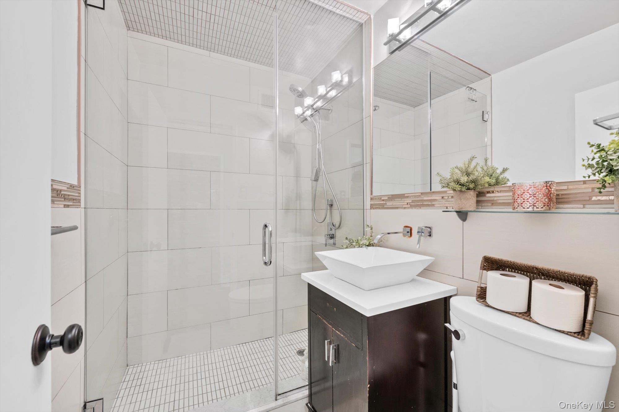 102-30 66th Road, Unit A28 Queens, NY 11375 - Photo 13 of 24 a bathroom with a sink a toilet and shower