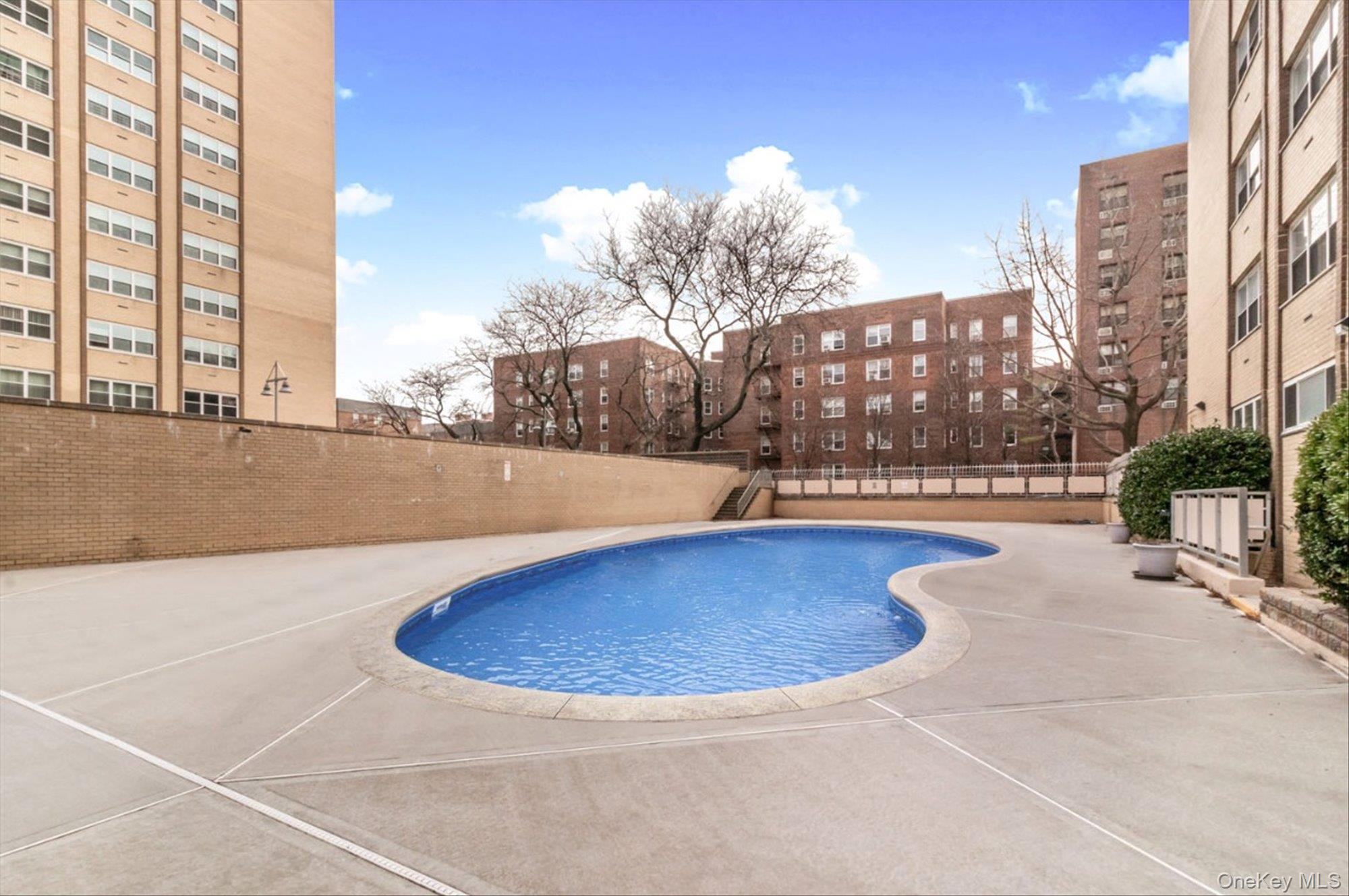 102-30 66th Road, Unit A28 Queens, NY 11375 - Photo 21 of 24 a view of a swimming pool with a terrace