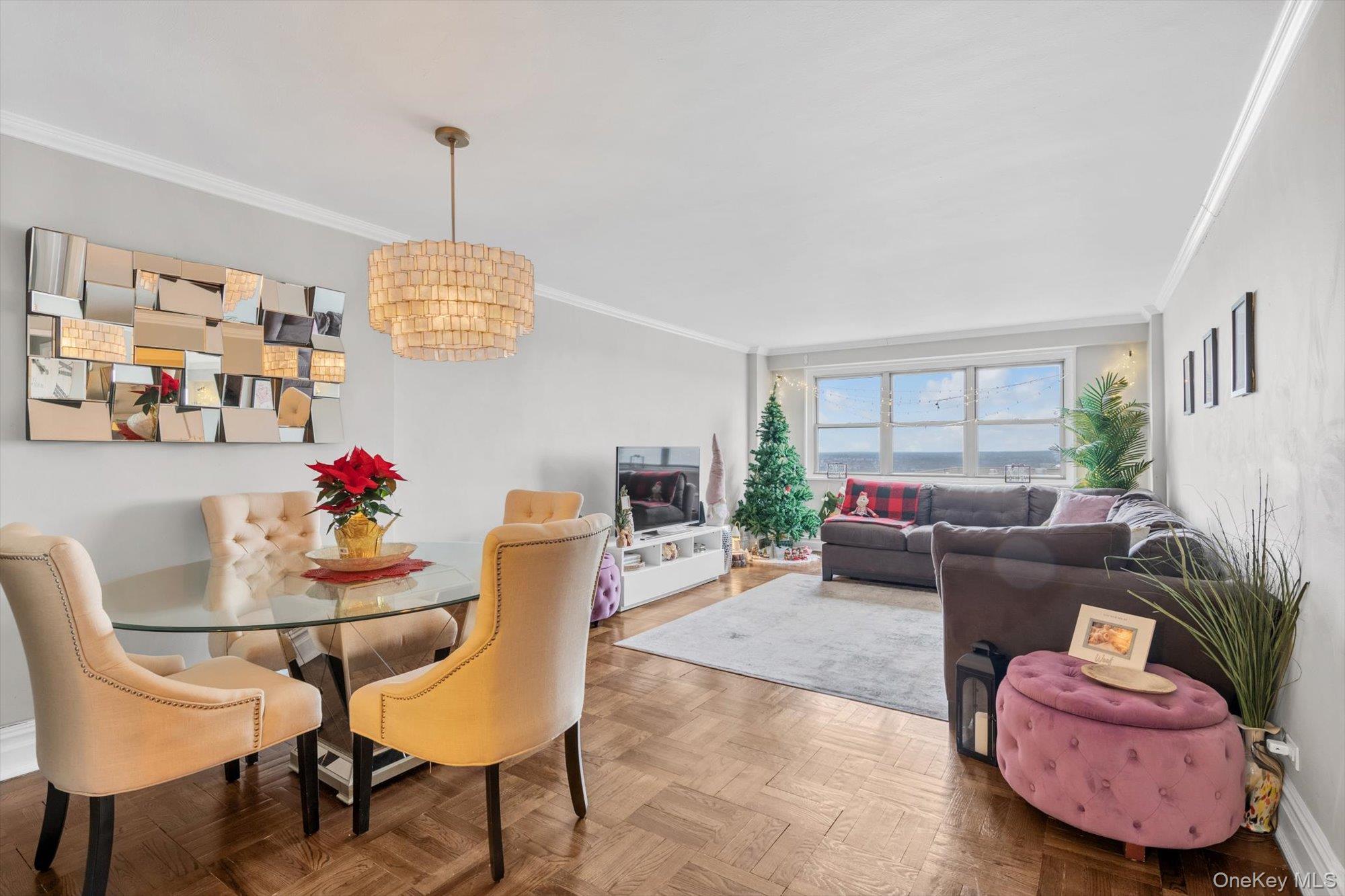 102-30 66th Road, Unit A28 Queens, NY 11375 - Photo 8 of 24 a living room with furniture and a chandelier