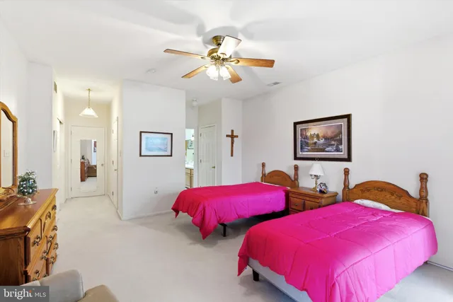 a bedroom with two beds and a chandelier