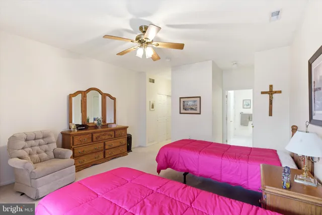 a bedroom with two bed and a couch