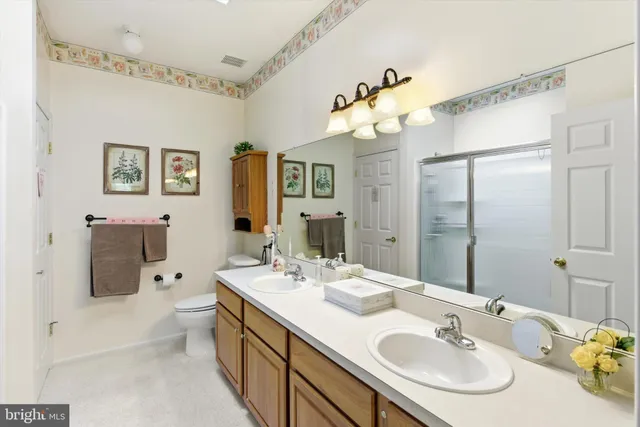 a bathroom with a double vanity sink mirror and double