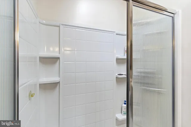 a bathroom that has a glass shower door