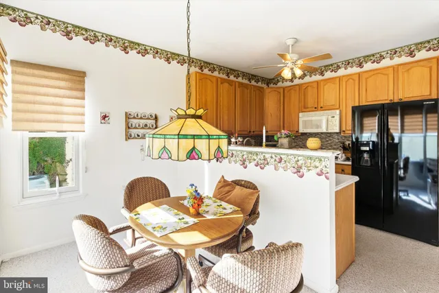 a kitchen with kitchen island a stove a dining table and chairs