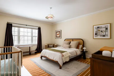 a spacious bedroom with a large bed and a large window