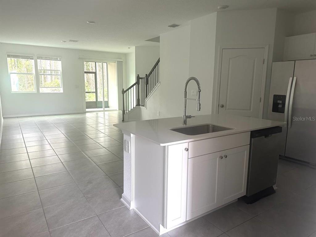 455 Redbud Road Palm Coast, FL 32137 - Photo 9 of 12 a view of a kitchen with a sink and a window