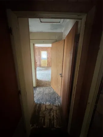 a view of hallway with wooden floor