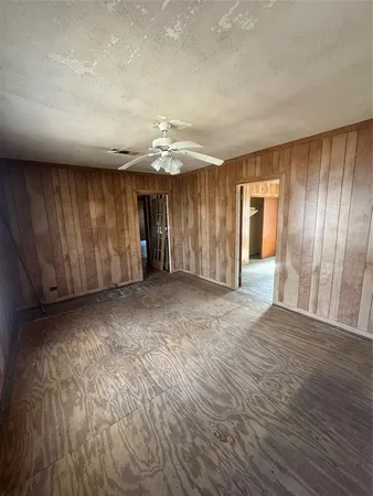 a living room with a table chairs and a refrigerator