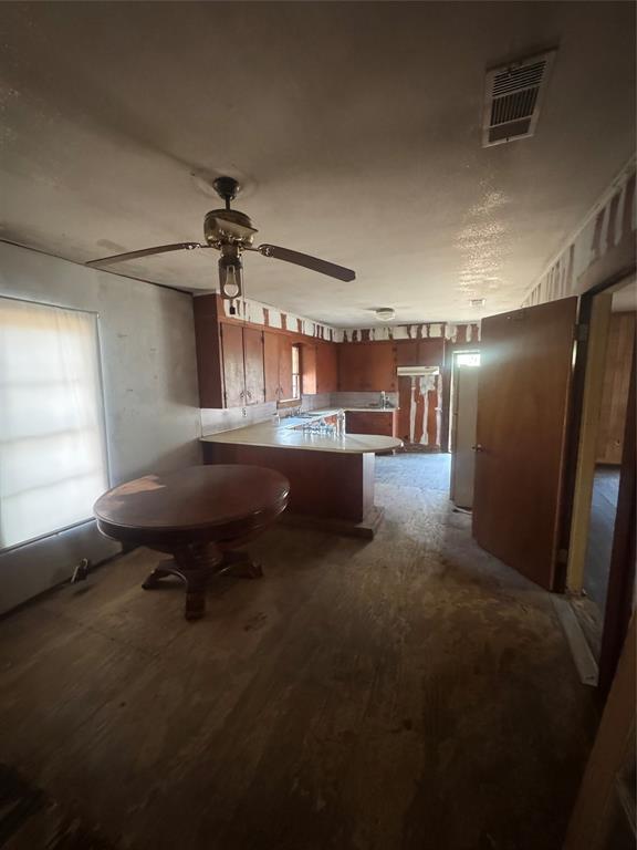 2980 Military Road Ringgold, LA 71068 - Photo 17 of 17 a living room with a table chairs and a refrigerator