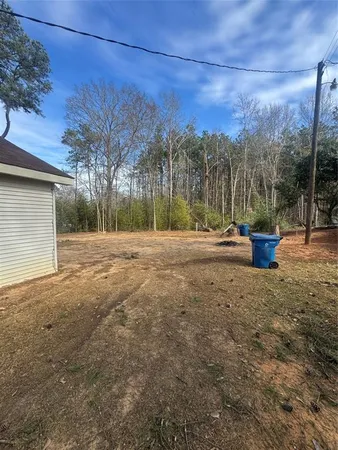 a backyard of a house with a tree and a yard
