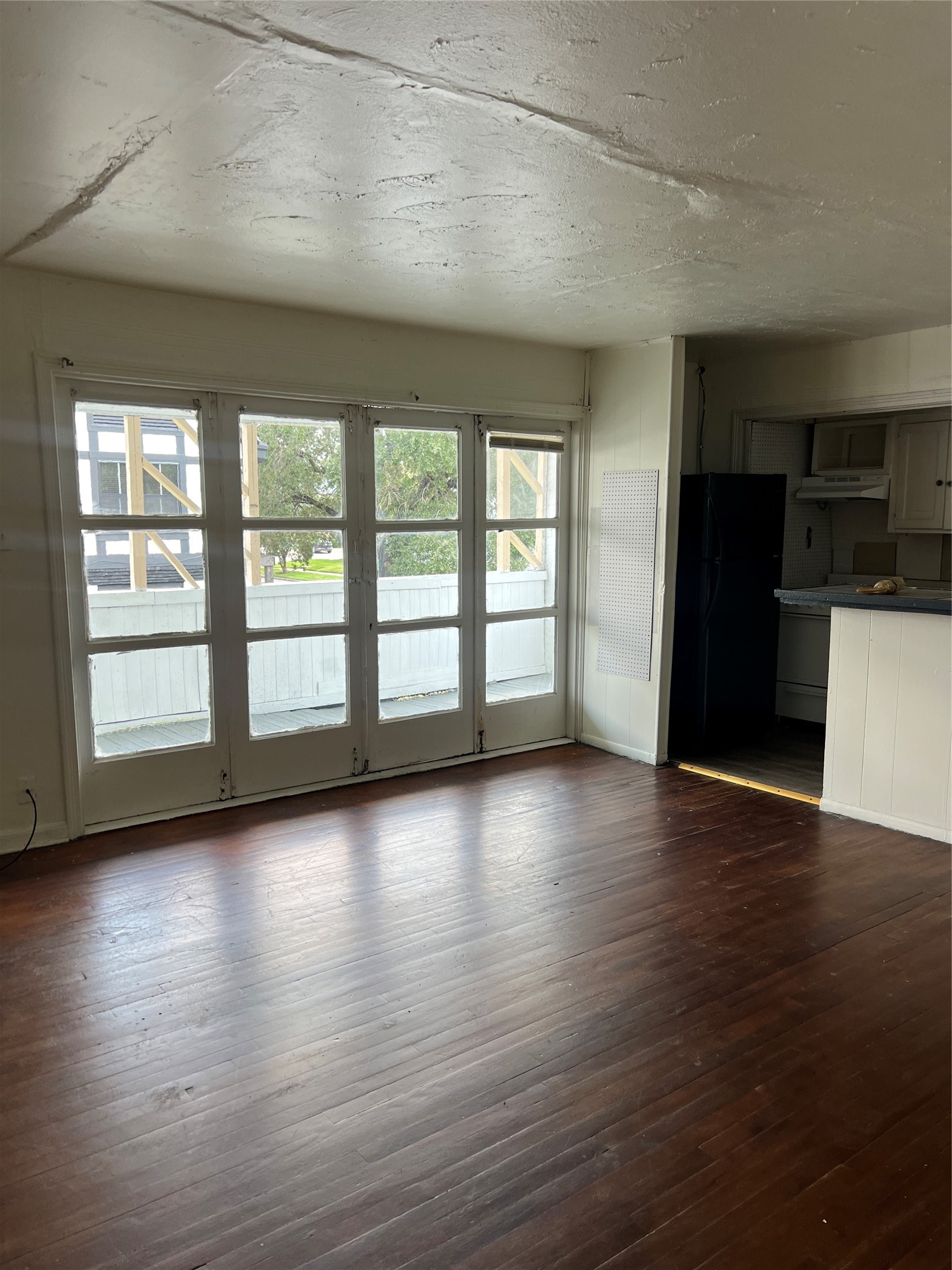 1905 Binz Street, Unit 6 Houston, TX 77004 - Photo 4 of 6 a view of an empty room with a window and wooden floor