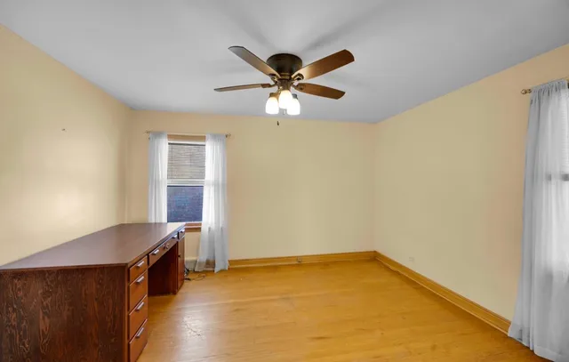 a view of room with window and ceiling fan