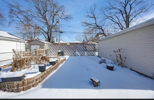 a view of a house with a snow in the yard