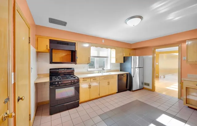 a kitchen with a stove a sink and a refrigerator