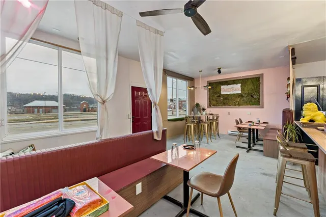a living room with furniture and a floor to ceiling window
