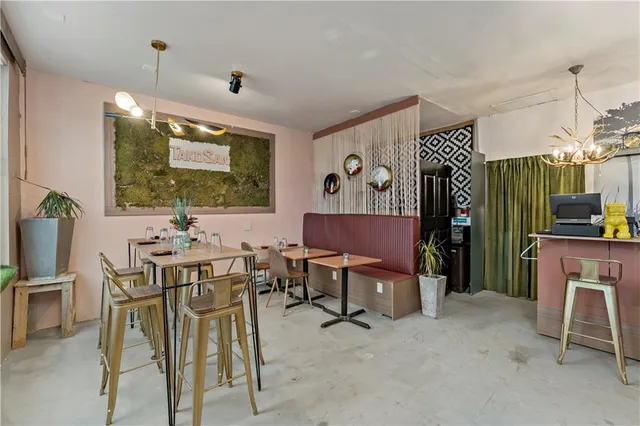 a view of a dining room with furniture and a potted plant