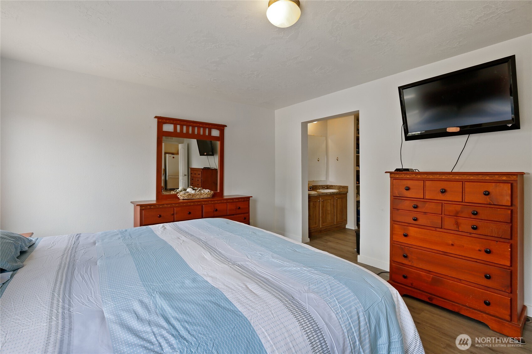 270 Romerman Road, Unit 34 Chehalis, WA 98532 - Photo 19 of 34 a bedroom with a bed and a flat screen tv