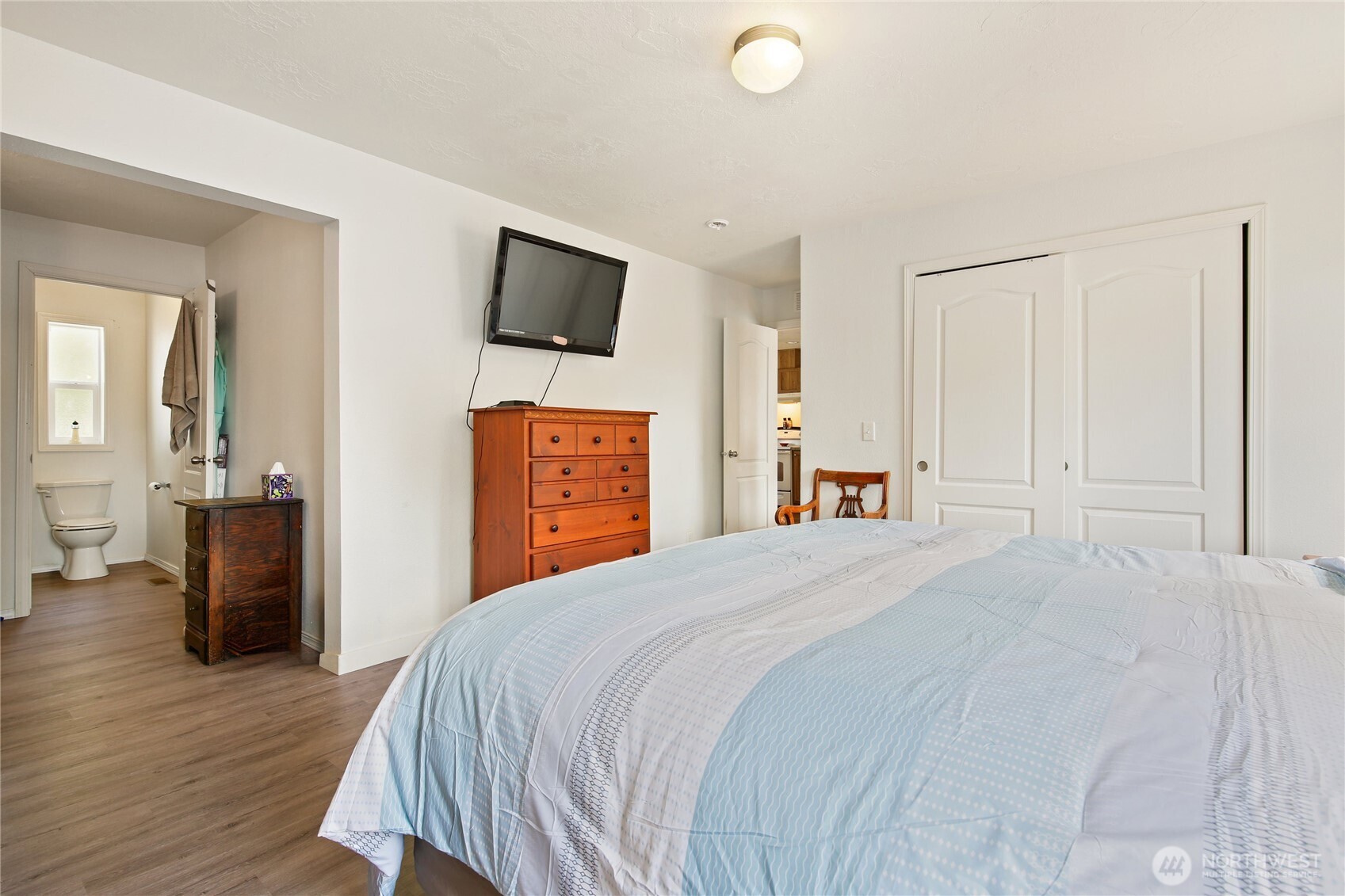 270 Romerman Road, Unit 34 Chehalis, WA 98532 - Photo 21 of 34 a bedroom with a bed and wooden floor