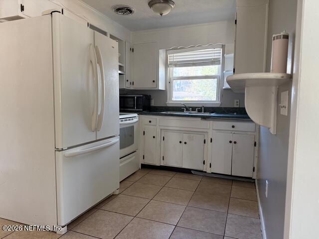 310 Noel Road Orange Park, FL 32073 - Photo 5 of 14 a kitchen with white cabinets and white appliances