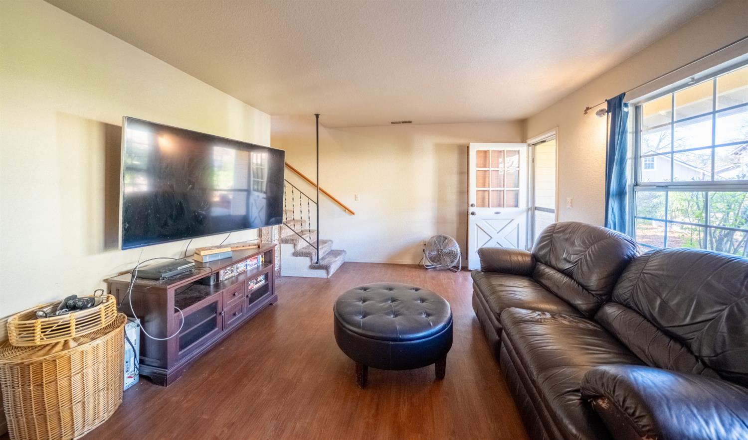 494 Surrey Court Murphys, CA 95247 - Photo 49 of 76 a living room with furniture and a flat screen tv