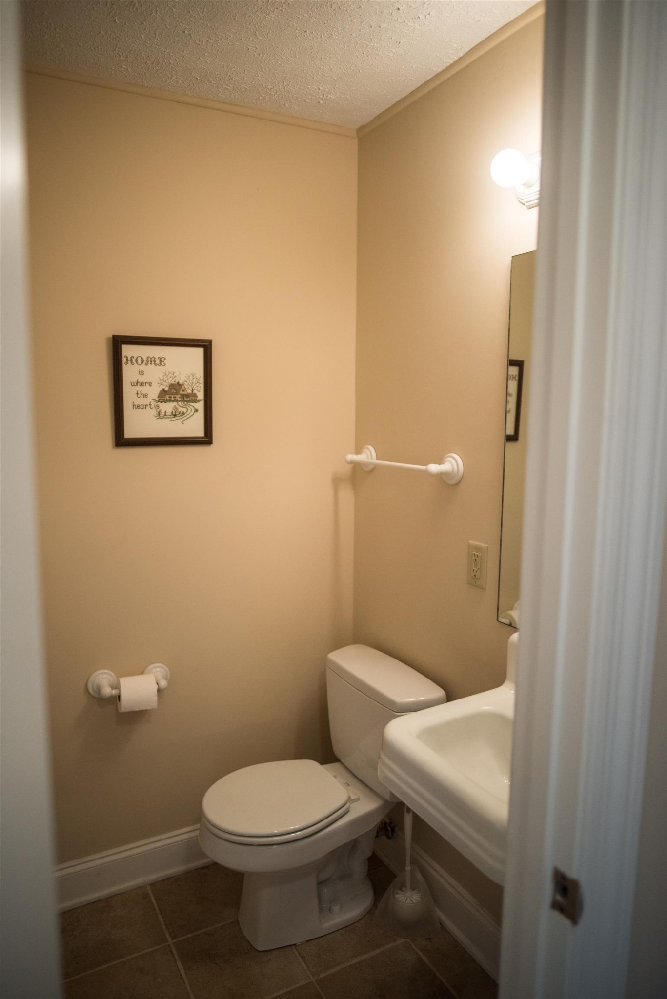 284 Lakewood Road Silver Point, TN 38582 - Photo 8 of 30 a white toilet sitting next to a bathroom sink