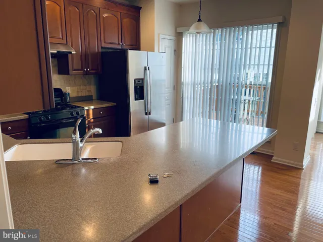 a kitchen with wooden cabinets and a stove top oven