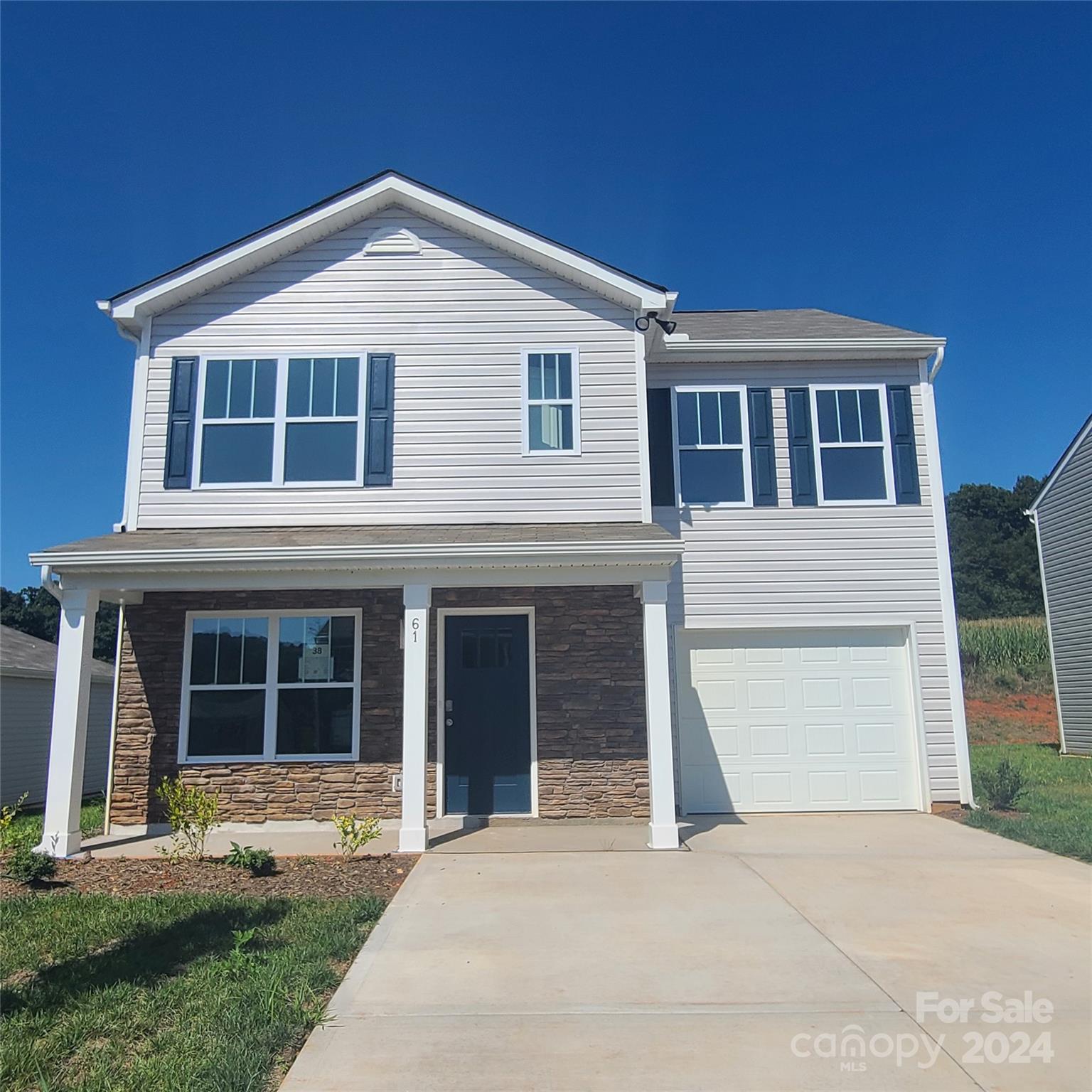 61 Callie River Clyde, NC 28721 - Photo 1 of 23 a front view of a house with a yard and garage