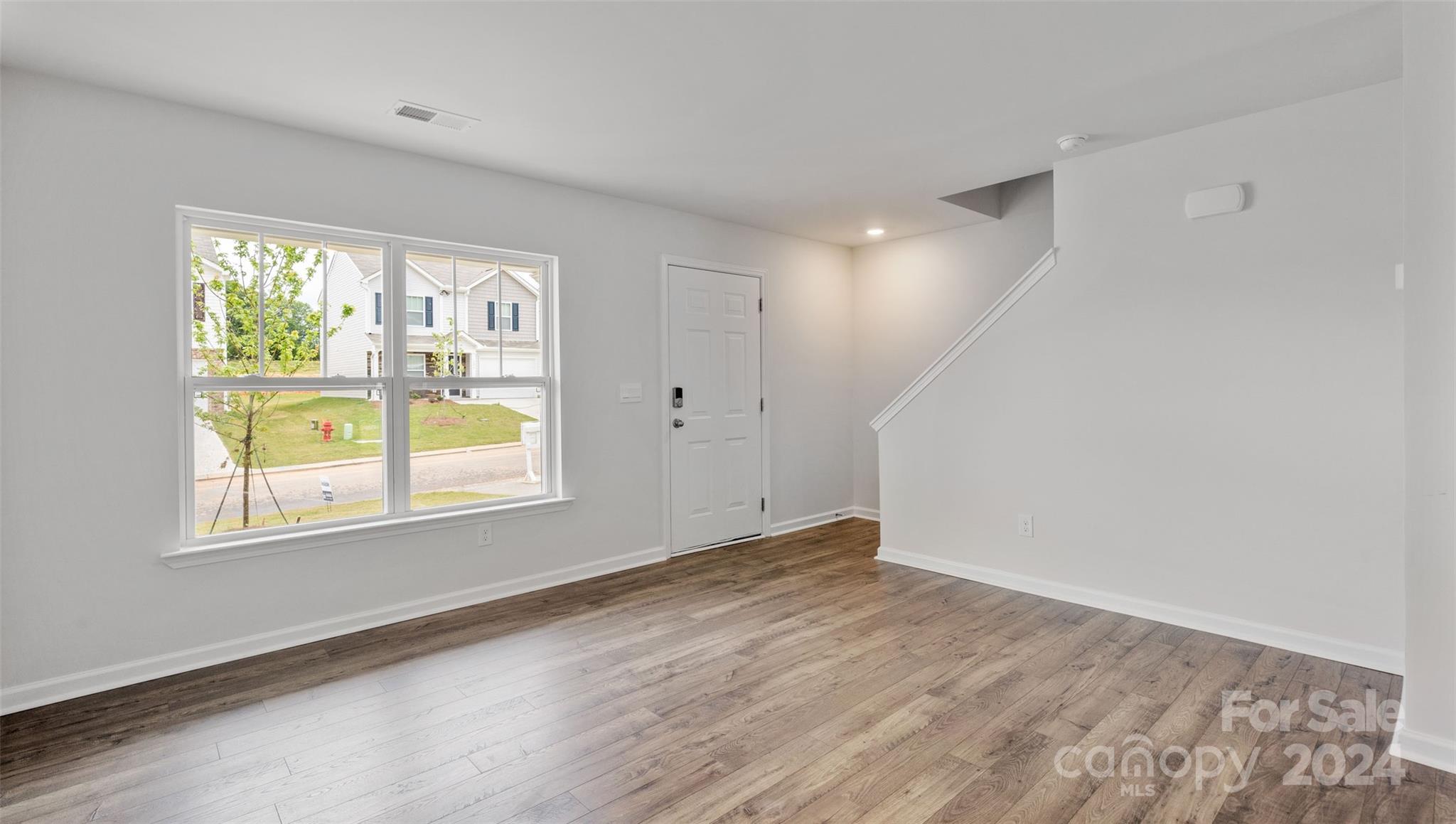 61 Callie River Clyde, NC 28721 - Photo 11 of 23 an empty room with a window and wooden floor