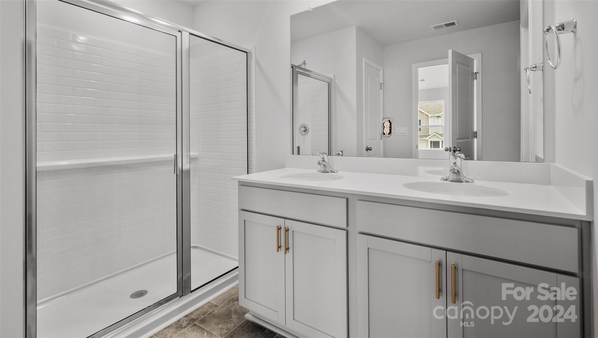 61 Callie River Clyde, NC 28721 - Photo 16 of 23 a bathroom with a shower sink and mirror
