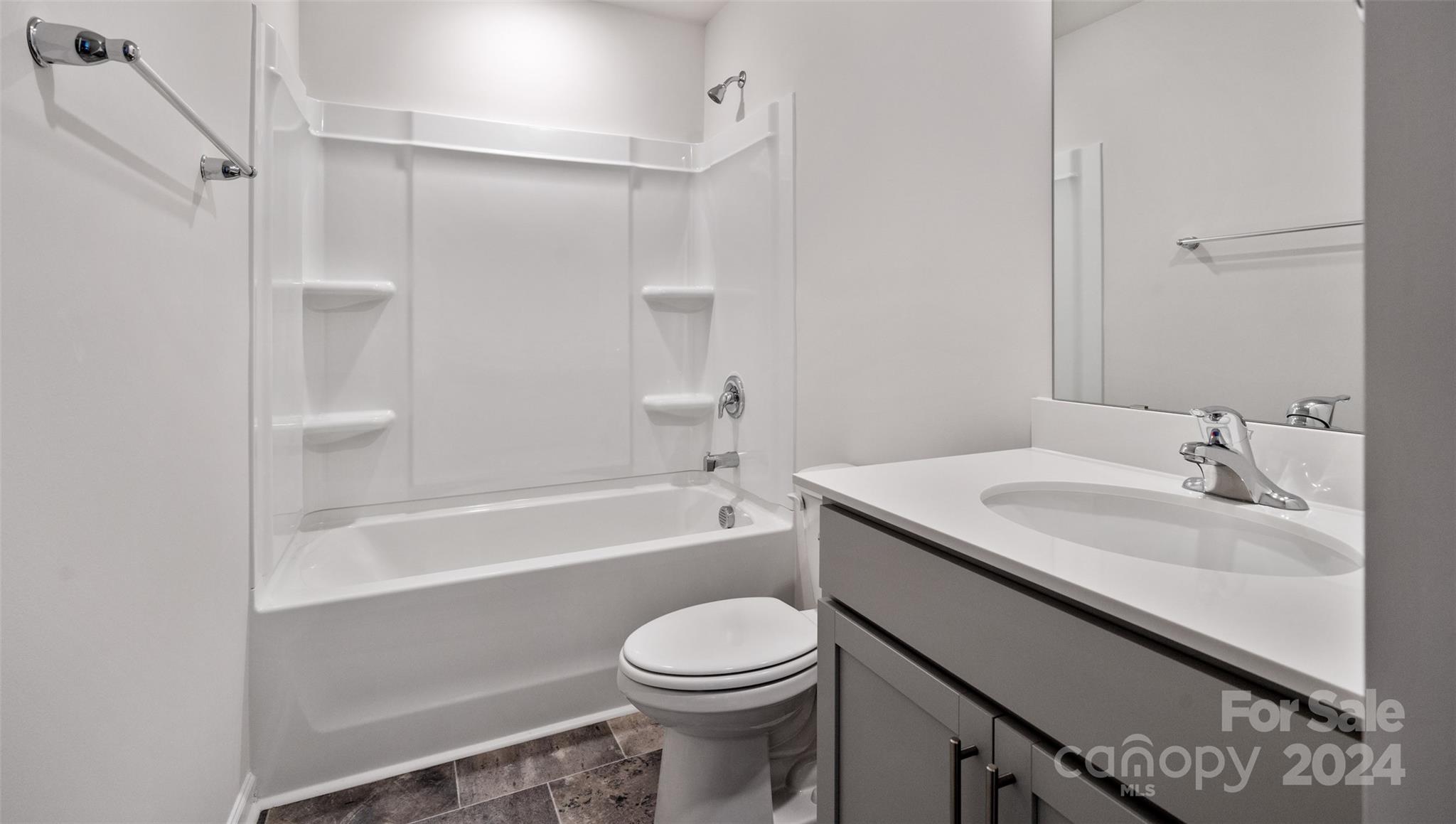 61 Callie River Clyde, NC 28721 - Photo 18 of 23 a bathroom with a sink a toilet and a bathtub