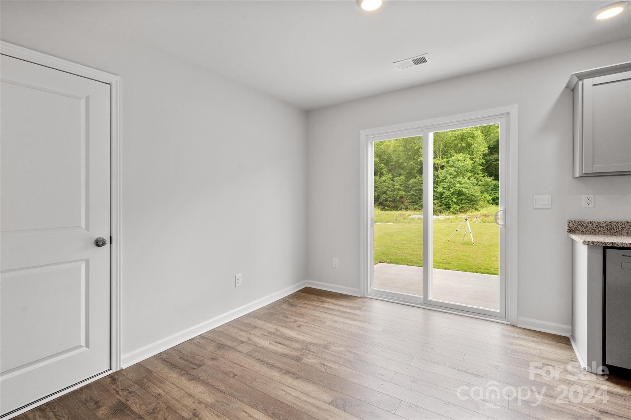 61 Callie River Clyde, NC 28721 - Photo 20 of 23 a view of an empty room with wooden floor and a window