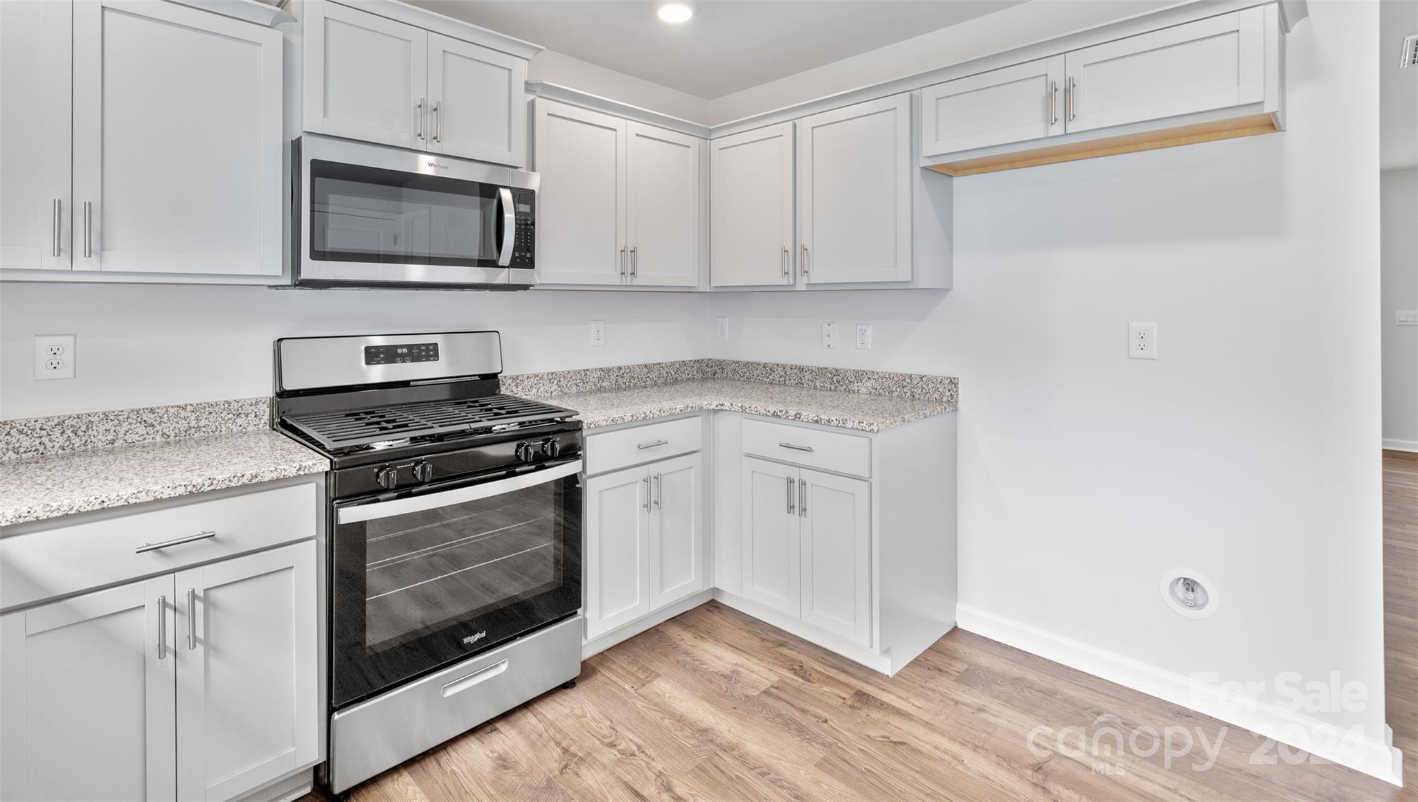 61 Callie River Clyde, NC 28721 - Photo 7 of 23 a kitchen with white cabinets stainless steel appliances and sink
