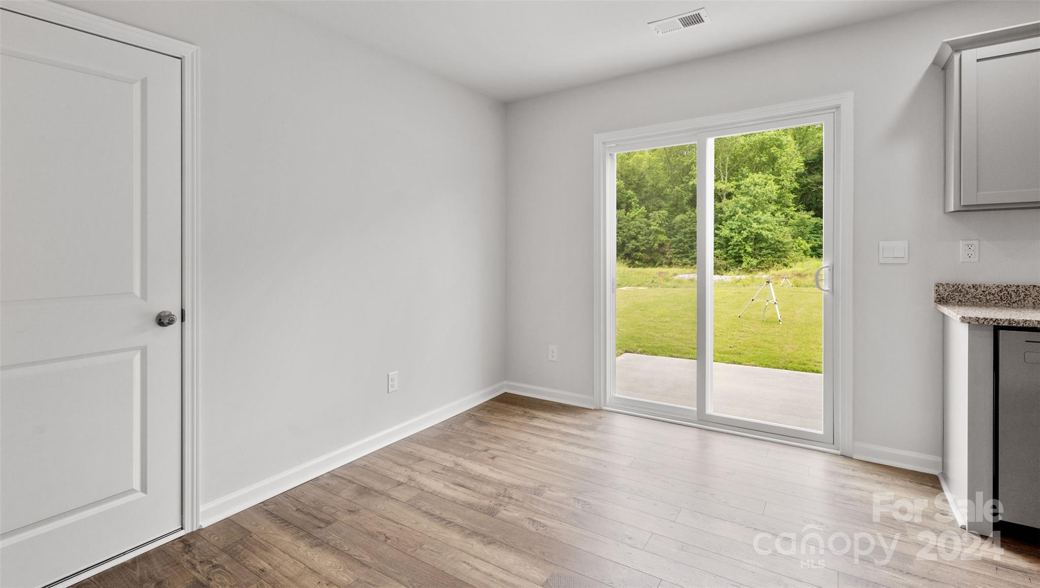 61 Callie River Clyde, NC 28721 - Photo 8 of 23 a view of an empty room with wooden floor and fan