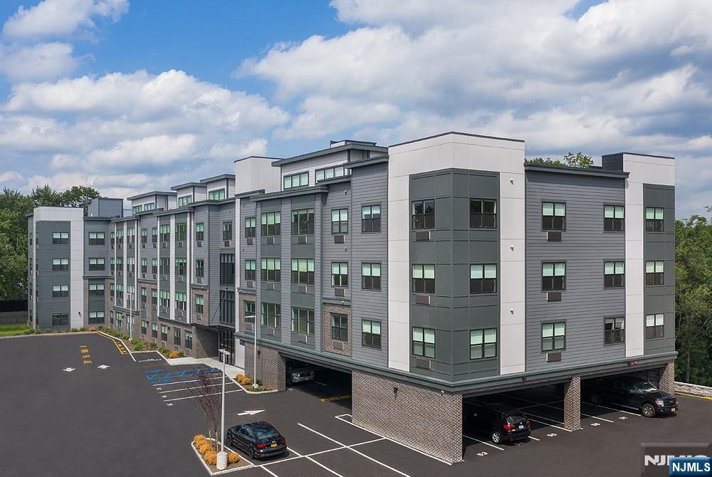 15 West Johnson Avenue, Unit 304 Bergenfield, NJ 07621 - Photo 5 of 15 a front view of a building with glass windows