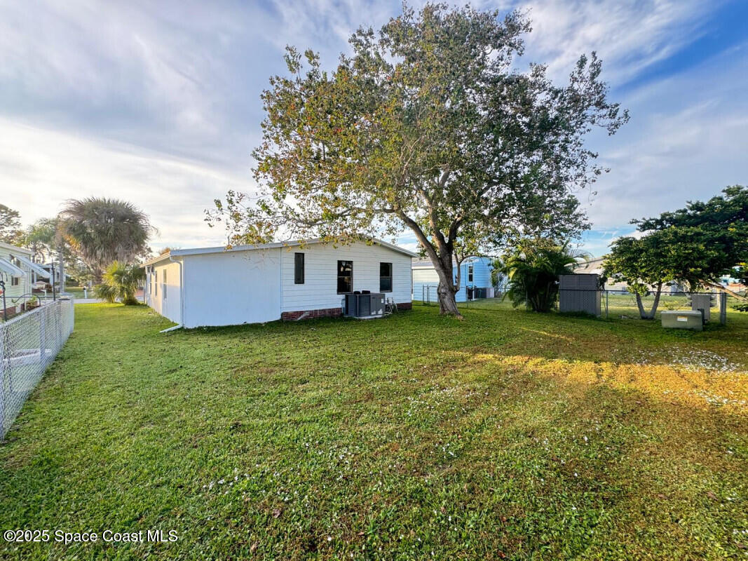 1973 Mango Street Northeast Palm Bay, FL 32905 - Photo 2 of 14 a view of a house with a yard