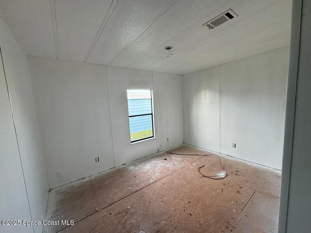 1973 Mango Street Northeast Palm Bay, FL 32905 - Photo 8 of 14 en empty room with windows