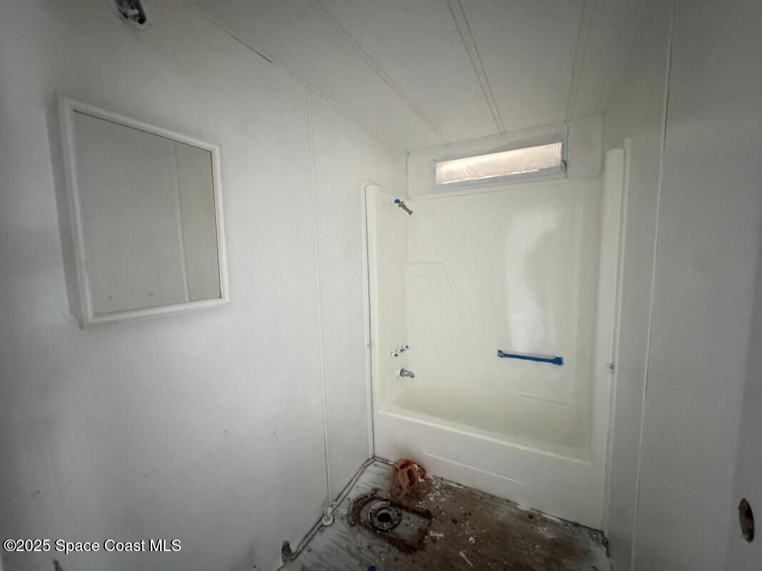 1973 Mango Street Northeast Palm Bay, FL 32905 - Photo 9 of 14 a bathroom with a bathtub