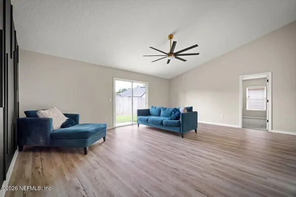 a living room with furniture and a wooden floor