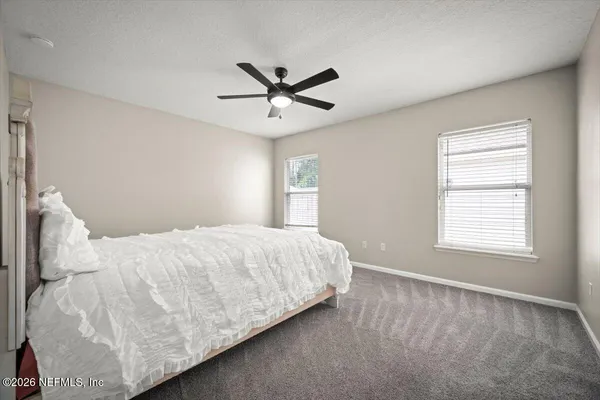 a bedroom with a bed and window