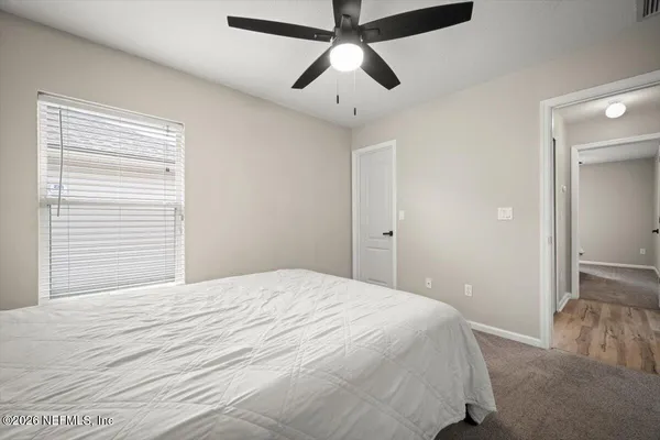 a bed sitting in a room next to a window