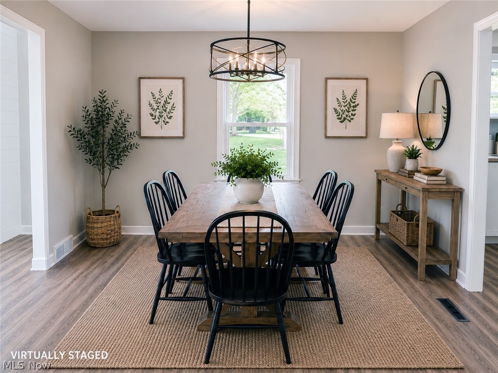 6666 Clingan Road Youngstown, OH 44514 - Photo 19 of 41 Dining area featuring wood-finish flooring, light grey walls, and white trim