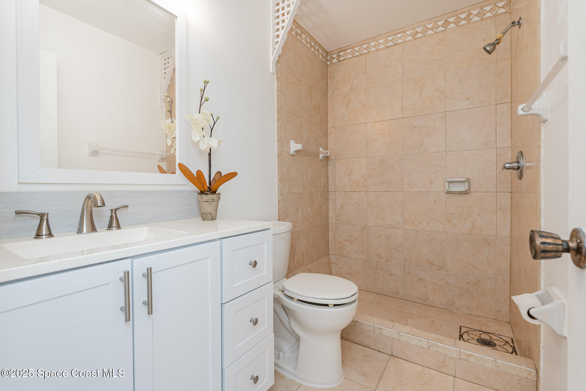 1411 Sheafe Avenue Northeast, Unit 101 Palm Bay, FL 32905 - Photo 15 of 25 a bathroom with a sink toilet and shower