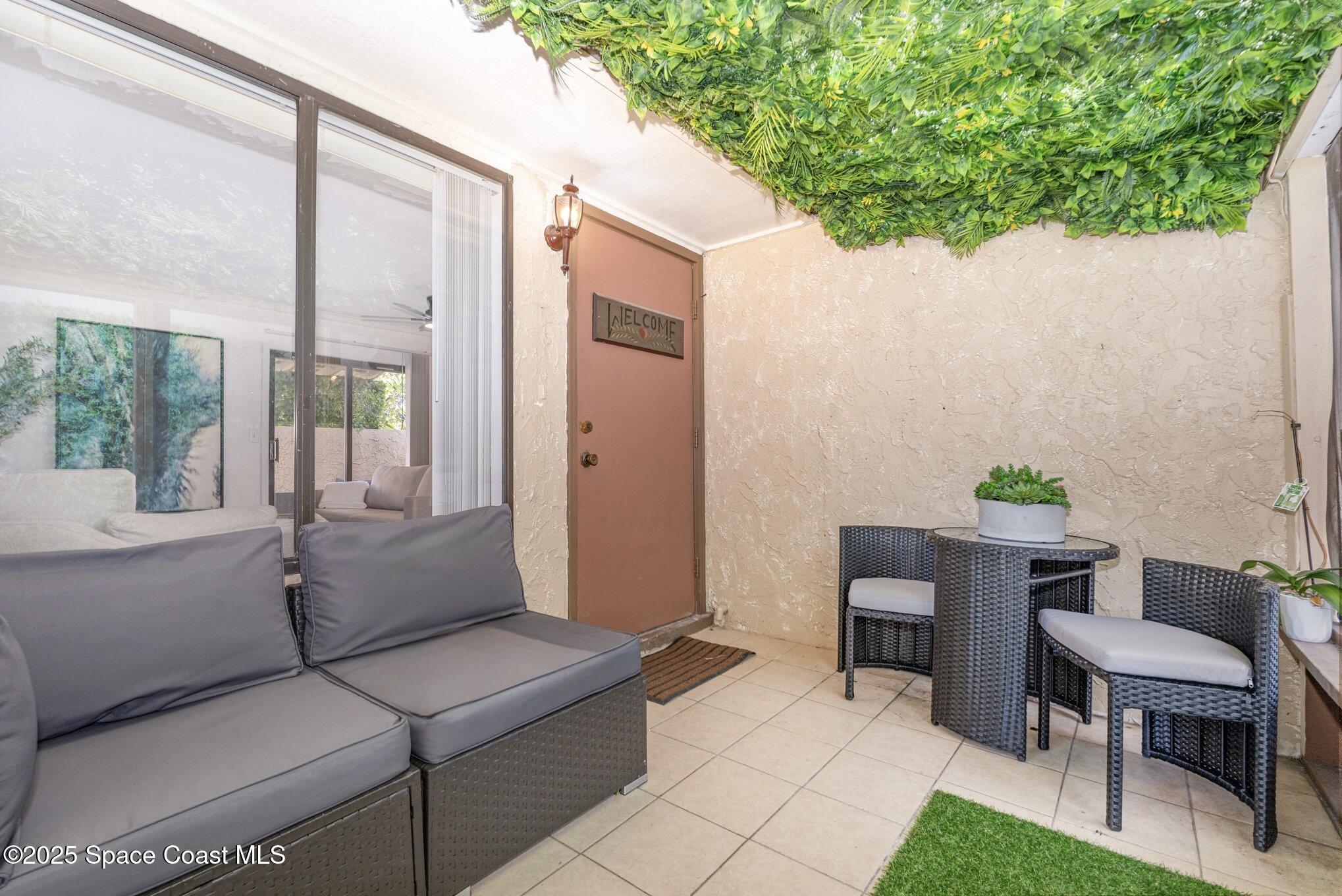 1411 Sheafe Avenue Northeast, Unit 101 Palm Bay, FL 32905 - Photo 17 of 25 a living room with furniture and a potted plant