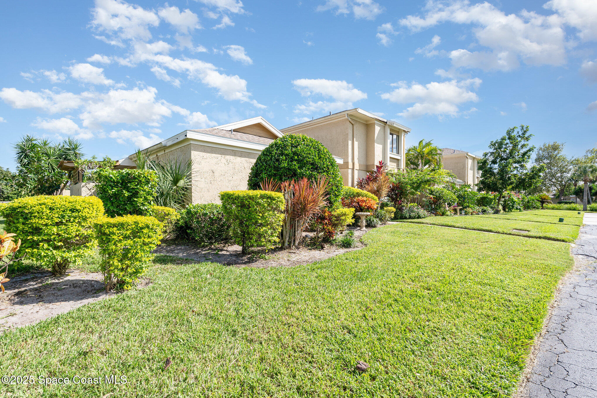 1411 Sheafe Avenue Northeast, Unit 101 Palm Bay, FL 32905 - Photo 19 of 25 a view of a house with a yard and potted plants