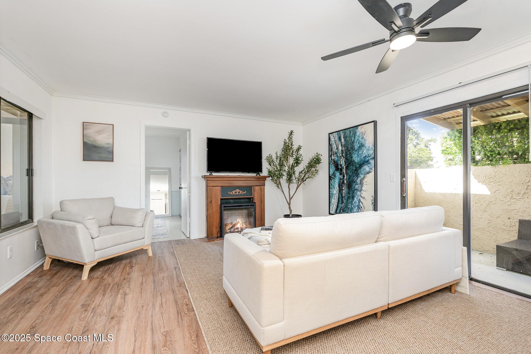 1411 Sheafe Avenue Northeast, Unit 101 Palm Bay, FL 32905 - Photo 7 of 25 a living room with furniture and a fireplace