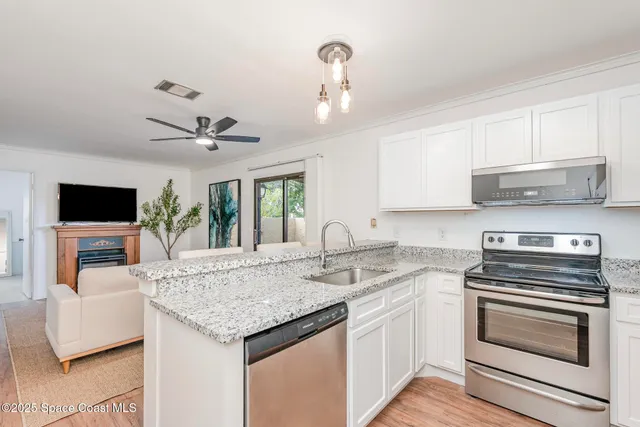 a kitchen with granite countertop a sink and cabinets