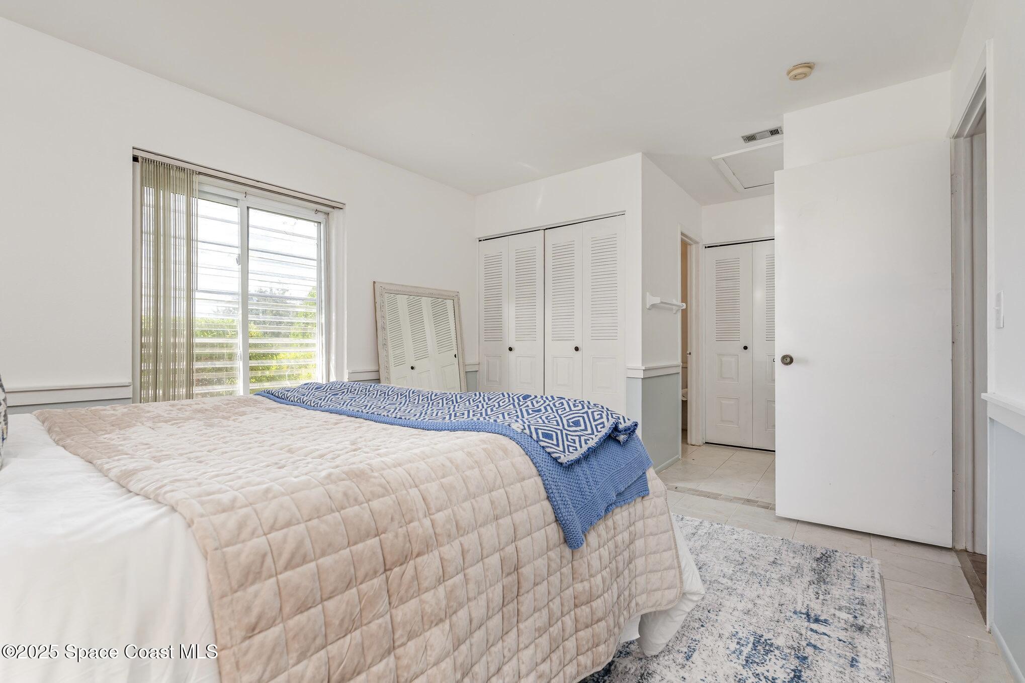 1411 Sheafe Avenue Northeast, Unit 101 Palm Bay, FL 32905 - Photo 10 of 25 a spacious bedroom with a bed and a window