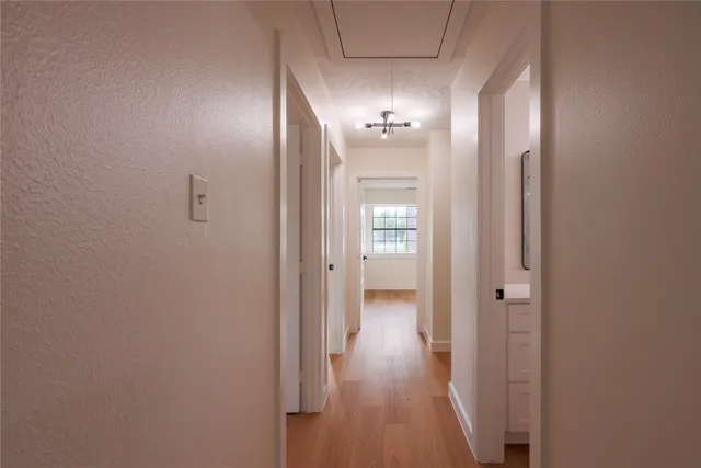 a view of a hallway with wooden floor