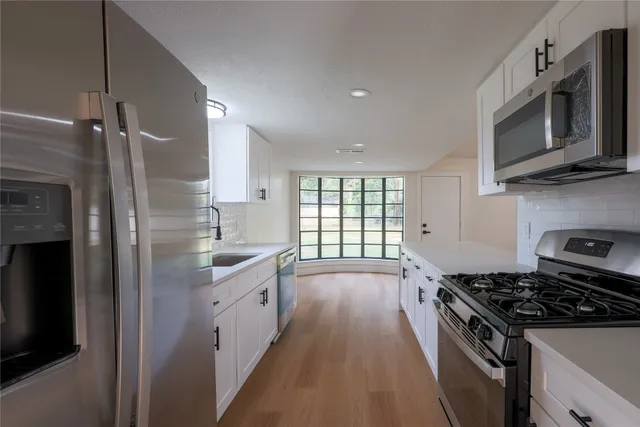 a kitchen with a sink stove and microwave