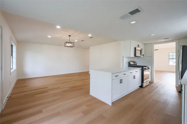 a kitchen with stainless steel appliances granite countertop a stove and a refrigerator